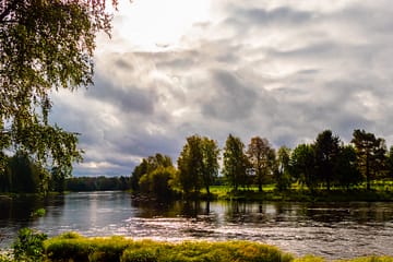 River and sun shining trough clouds